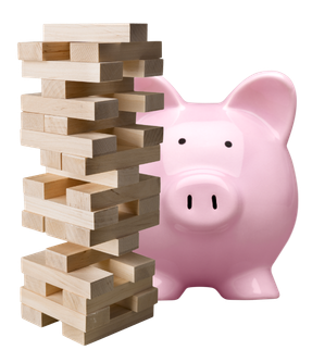 A pink piggy bank standing behind a tower of Jenga blocks.